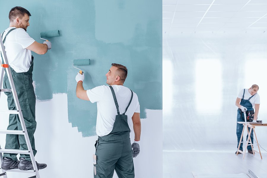 painter with gloves painting wall